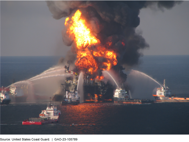 Supply boats trying to put out a massive fire on an oil drilling rig in the middle of the ocean.