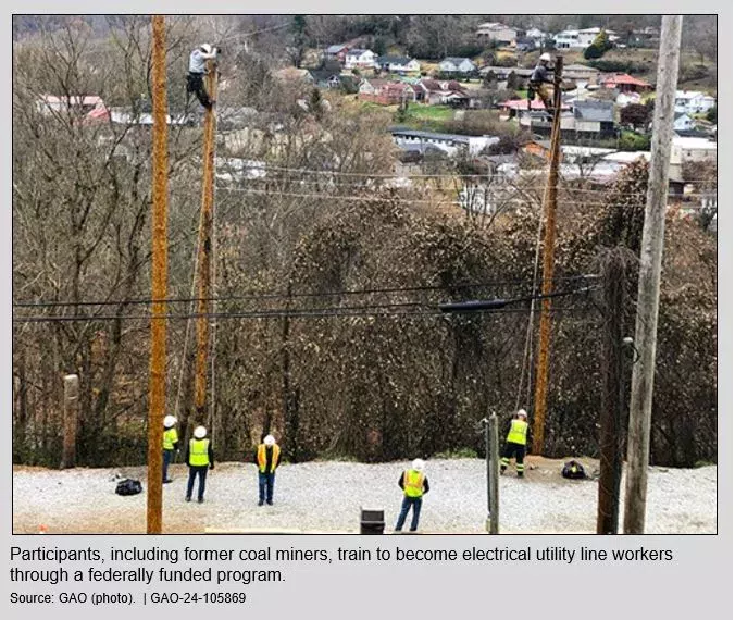 Photo showing people wearing hardhats and yellow vests working on power line poles.